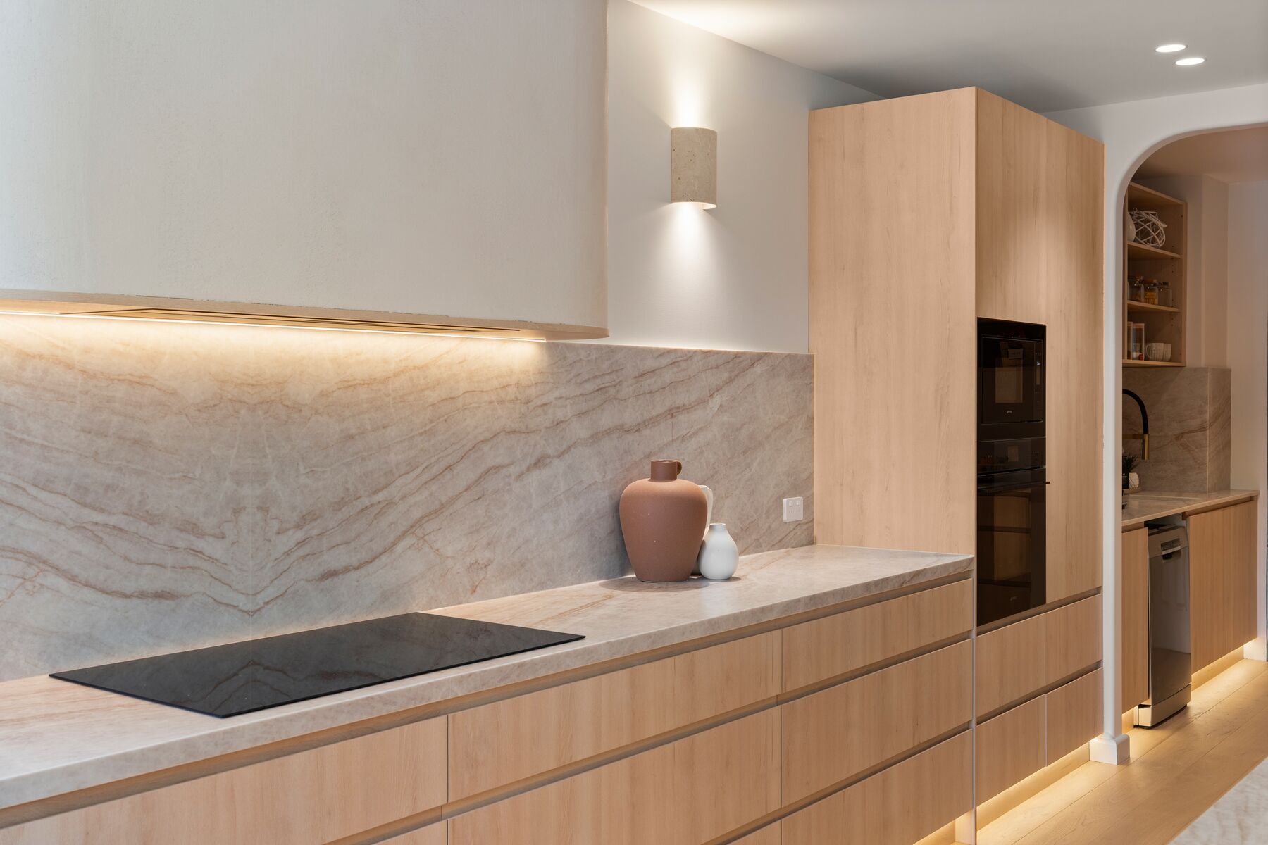 Kitchen island with stools and LED lighting under the stone benchtop