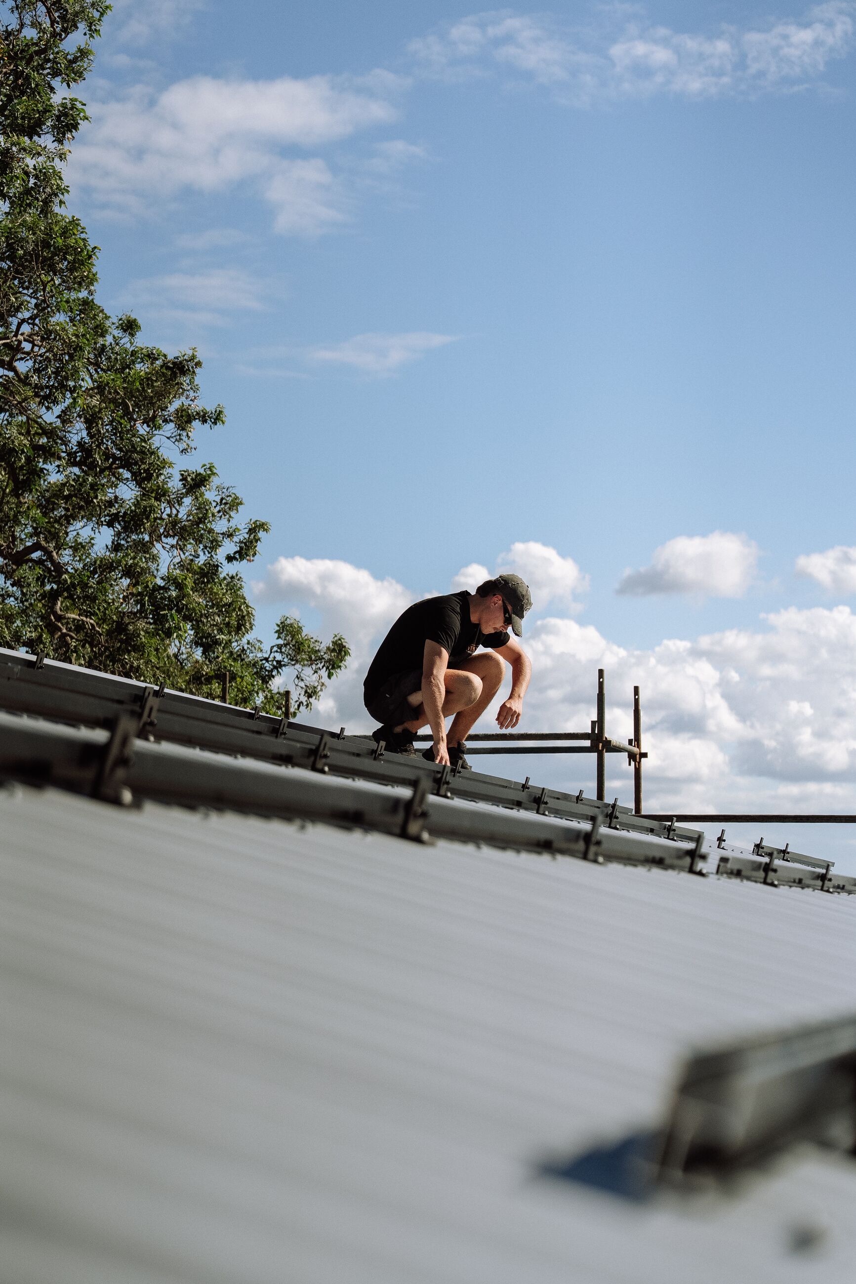 Fusion installers fixing solar mounting rails to a metal roof